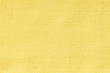 Yellow linen fabric of cloth texture background. Detail of textile material close-up.