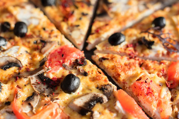 Pizza, food, vegetable, mushrooms.  Vegetables, mushrooms and tomatoes pizza on a black wooden background. It can be used as a background