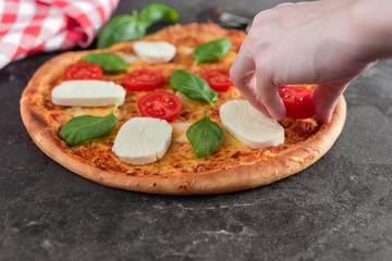 Pizza, food, vegetable, margarita.  Vegetables, mushrooms and tomatoes pizza in a human hand. It can be used as a background