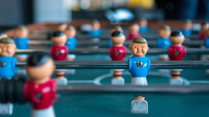 Table football with blue and red figures