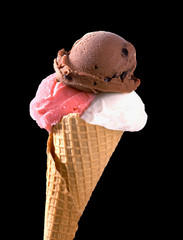 chocolate, strawberry and vanilla ice cream scoops with cone isolated on black background