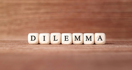 Word DILEMMA made with wood building blocks
