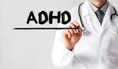 Doctor writing word ADHD with marker, Medical concept