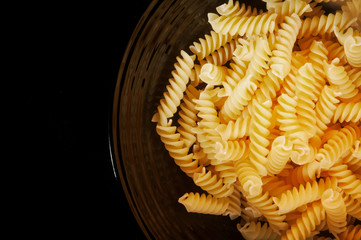 Close up of a black bowl filled with fusilli pasta
