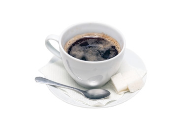 Naklejka premium Cup of black coffee on a saucer with a napkin, a teaspoon and lumps of sugar