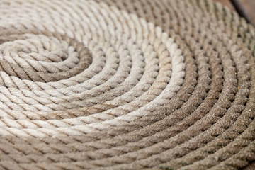 Fototapeta na wymiar flat layed rolled up, nautical rope close up