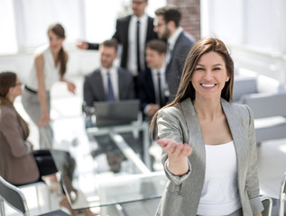 smiling business woman inviting you into her office