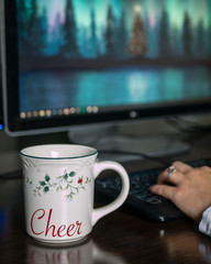 Christmas mug in front of computer
