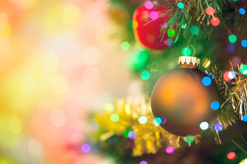 Christmas tree decorated with ornaments and multi colored lights with copy space background