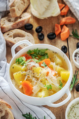 vegetable soup in a white plate on a wooden table