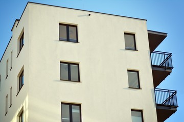 Fototapeta na wymiar Modern apartment buildings on a sunny day with a blue sky. Facade of a modern apartment building