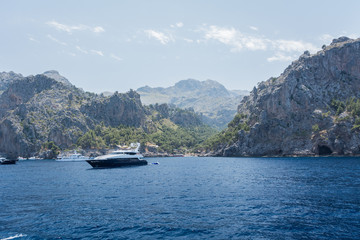 Puerto de Sa Calobra, Mallorca, Spain - July 20, 2013: View of yachts, rocks and bay