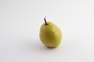 Ripe pear isolated on a white background. Pear with copy space for text. Green pear close-up. Pear on white background.