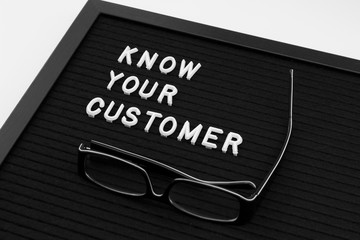 Know Your Customer - business concept, white text message on black board with glasses