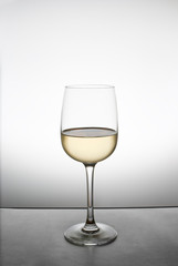 splash of white wine in a glass