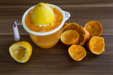 Fresh orange juice and lemonade in glasses.orange and lemon are a vitamin C store. Drinking natural fruit juice for healthy living. the woman squeezes fruit.