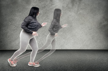 plus-sized woman runs to her thin shadow on the wall, the concept of losing weight