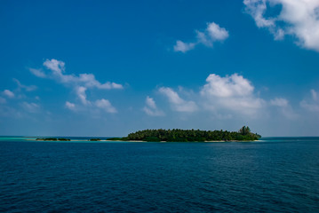 The islands and atolls of the Maldives in the tropical waters of the Indian Ocean