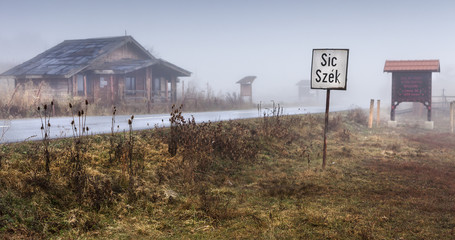 Village sign on a foggy morning at the entrance of  Sic village, Transylvania, Romania