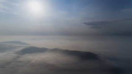 Aerial view from a drone about the Transylvanian valleys on a foggy morning, above Sic village, Transylvania,  Romania