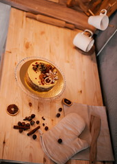 Christmas cake with oranges and nuts on a wooden background. Raw dessert