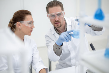 close up.two scientists discuss the results of testing.