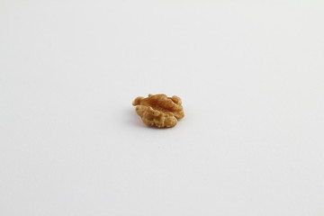 Half a walnut shelled on a white background