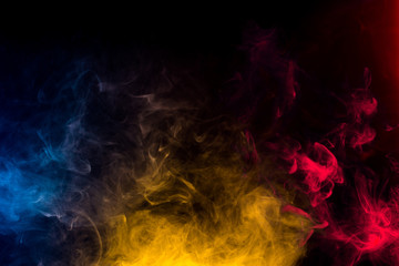 red blue and yellow smoke isolated on black background
