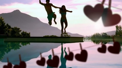 Happy couple jumping in a lake and hearts for valentine day