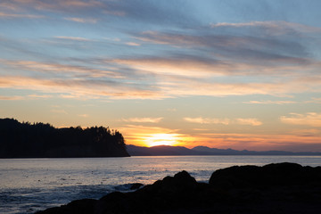 pacific northwest beach sunset over ocean horizon