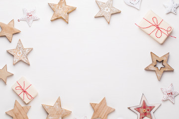 Fototapeta na wymiar Christmas composition. Wooden decorations, stars on white background. Christmas, winter, new year concept. Flat lay, top view, copy space.