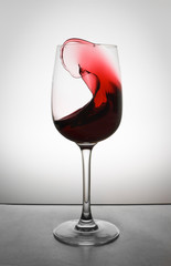 red wine splashing in glass