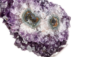 Macro mineral stone Amethyst eye, in the form of an owl on a white background