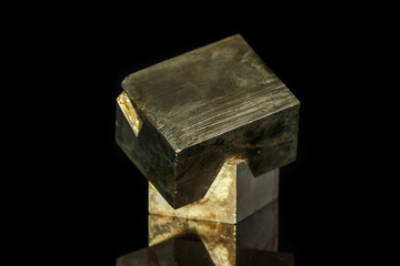 Macro mineral stone Pyrite on a black background