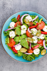 Vegetable salad with cheese mozzarella, tomatoes, basilikum and spice.