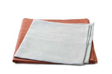 Folded brown and gray textile napkins stacked on white background