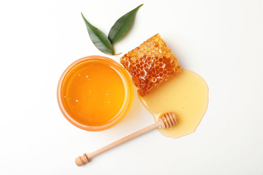 Composition with fresh honey on white background, top view