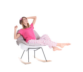 Fototapeta na wymiar Young woman relaxing in armchair on white background
