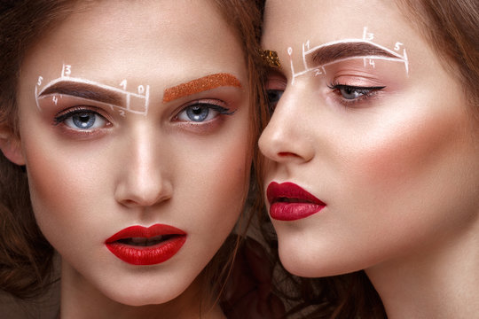 Two girls are twin sisters with an unusual eyebrow makeup. Beauty face.