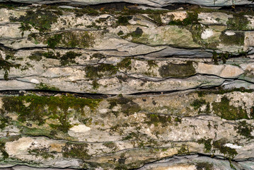 background, texture - mossy layered natural stone, limestone canyon wall
