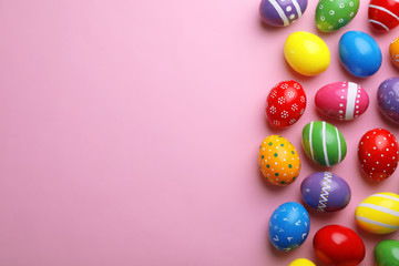 Decorated Easter eggs and space for text on color background, top view