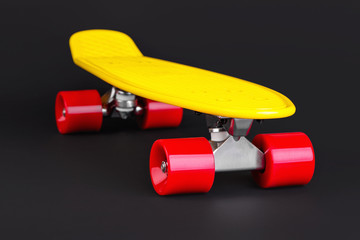 Yellow cruiser penny plastboard with red wheels