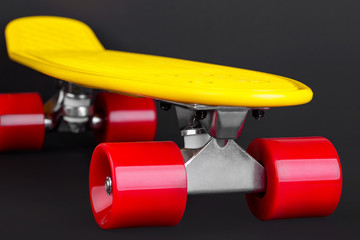 Yellow cruiser penny plastboard with red wheels