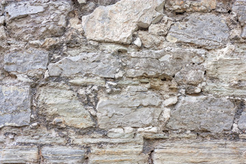 Old weathered brick wall of medieval fortress, horizontal grunge background