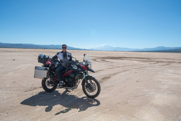 Fototapeta na wymiar young men with motorcycle at desert
