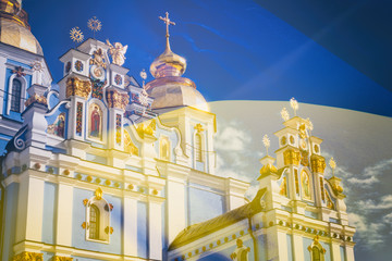 Obraz premium View of the St. Michaels Golden-Domed Monastery in Kiev, the Ukrainian Orthodox Church - Kiev Patriarchate, in the background flag of Ukraine, double exposure photo