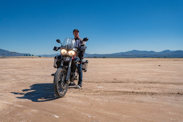 young men with motorcycle at desert