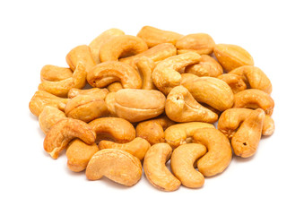 Handful of roasted cashew seeds (Anacardium occidentale) without shell, close up, isolated on white background