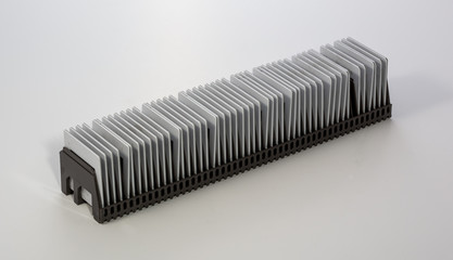 stack of 35mm positive film pictures in a magazine ready for projection