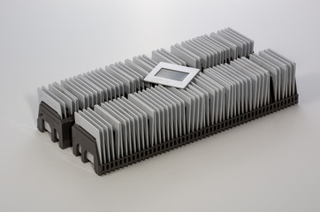 stack of 35mm positive film pictures in a magazine ready for projection